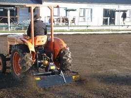 Using a rotary hoe to prepare the old surface of Green 1..jpg
